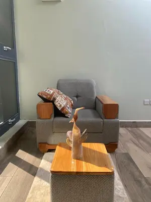 a living room with a couch and a coffee table at Serene Vacay Hotel Marangu in Marangu
