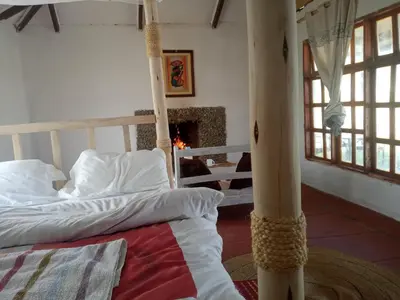 a bedroom with two bunk beds and a fireplace at Eco Farm in Karatu