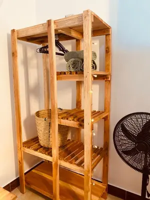 a wooden book shelf with a basket on it at Tukutane Kilimanjaro - Homestay in Uru