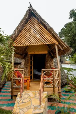 a small house with a thatched roof at Moshi hostel lodge in Msaranga