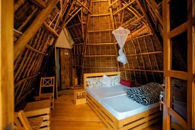 a bedroom with a bed in a bamboo house at Moshi hostel lodge in Msaranga