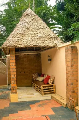a small hut with a couch in a patio at Moshi hostel lodge in Msaranga