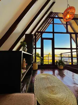 a living room with a table and a large window at Sereno Cabana in Arusha