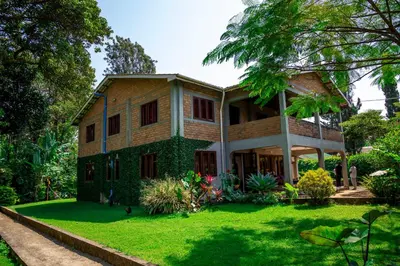 a house with a green lawn in front of it at The FAMILY FARM in Arusha