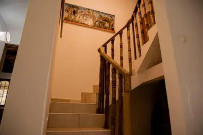 a staircase in a house with a painting on the wall at The FAMILY FARM in Arusha