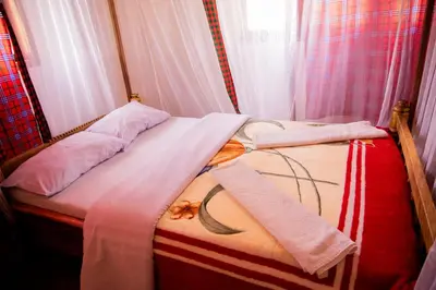 a couple of beds in a room at The FAMILY FARM in Arusha