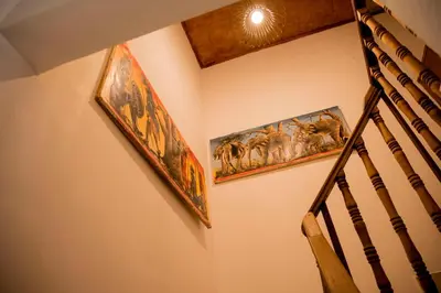a staircase with two pictures of animals on the wall at The FAMILY FARM in Arusha