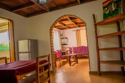 a kitchen with an archway in a room with a refrigerator at The FAMILY FARM in Arusha