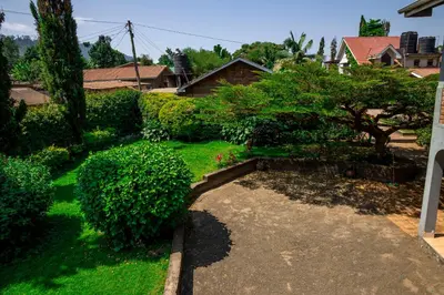 a garden with green bushes and a walk way at The FAMILY FARM in Arusha