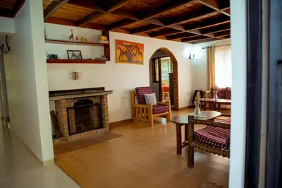 a living room with a fireplace and a table at The FAMILY FARM in Arusha