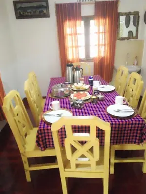 a dining room table with a purple and white table cloth at Moshi hostel lodge TANZANIA in Moshi