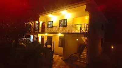 a building with a balcony and stairs at night at Silent Inn Apartments in Arusha