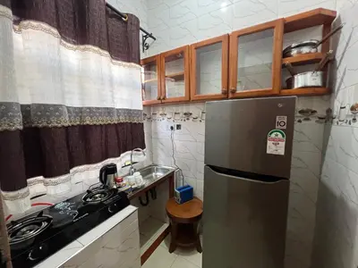 a kitchen with a stainless steel refrigerator and a sink at Beego Apartments in Arusha