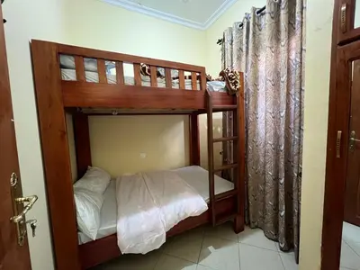 a bedroom with two bunk beds in a room at Beego Apartments in Arusha