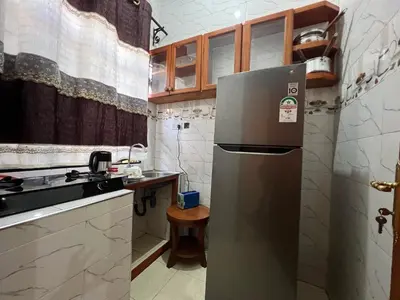 a kitchen with a refrigerator and a sink at Beego Apartments in Arusha