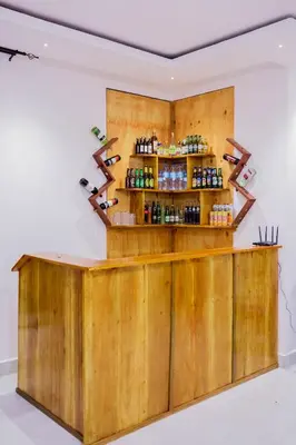 a wooden bar in a room with a shelf at Heim Villa in Kahe
