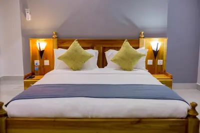 a bedroom with a large wooden bed with pillows at Heim Villa in Kahe