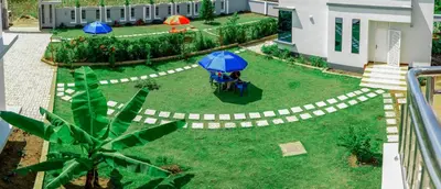 an aerial view of a garden with a table and umbrellas at Heim Villa in Kahe