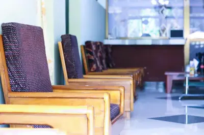 a row of wooden chairs sitting in a room at Bamboo Savannah in Arusha