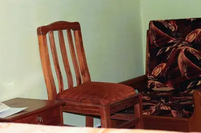 a room with a chair and a table and a desk at Bamboo Savannah in Arusha