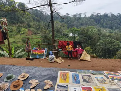 a group of children sitting in front of a tent at Jangwani River View Suits in Mto wa Mbu