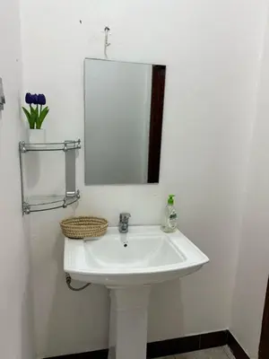 a white sink in a bathroom with a mirror at Logic stays 3 bedroom Arusha, Njiro in Arusha