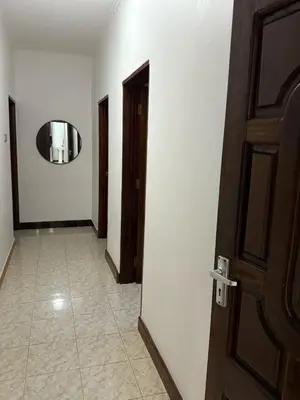a hallway with a door and a mirror on the wall at Logic stays 3 bedroom Arusha, Njiro in Arusha
