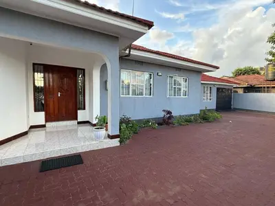 a house with a brick driveway in front of it at Logic stays 3 bedroom Arusha, Njiro in Arusha