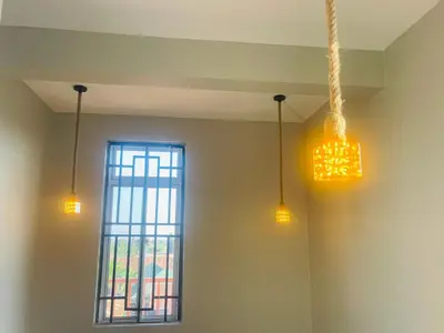a room with three lights and a window at Triple s homes in Arusha