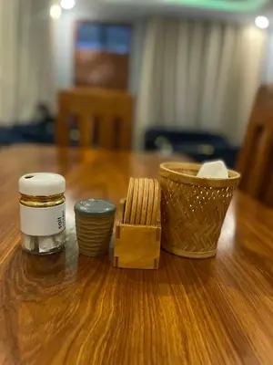 a wooden table with two jars and a basket on it at Triple s homes in Arusha