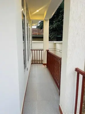 a hallway of a building with a balcony at Triple s homes in Arusha