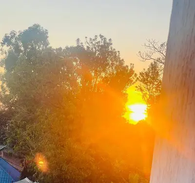 a view of the sunset from the window of a house at Triple s homes in Arusha
