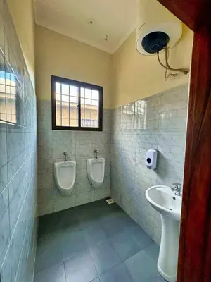 a bathroom with two urinals and a sink at Moshono Hillside in Arusha