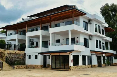 a large white building with a roof at Moshono Hillside in Arusha