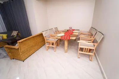 a dining room with a table and chairs at Pembeni River House in Arusha