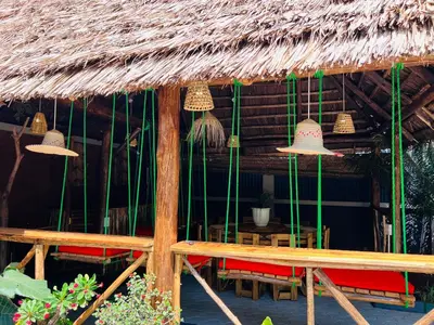 a hut with a table and chairs and bells at Villa Rosa in Moshi