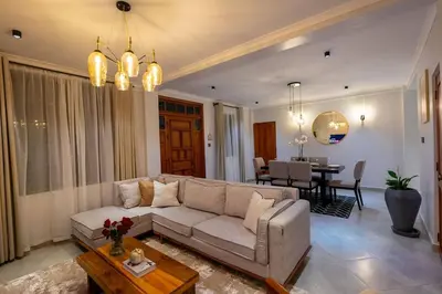 a living room with a couch and a table at Serenita Homes Arusha in Arusha