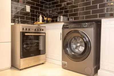 a washing machine and a washer in a kitchen at Serenita Homes Arusha in Arusha