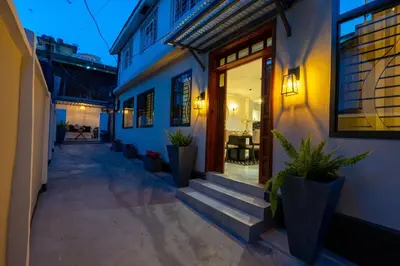 a building with stairs and potted plants in front of it at Serenita Homes Arusha in Arusha