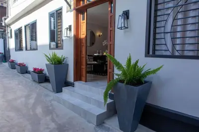 a stairway with potted plants in front of a building at Serenita Homes Arusha in Arusha