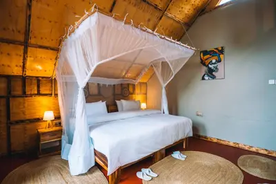 a bedroom with a bed with a canopy at Samora River Lodge in Arusha