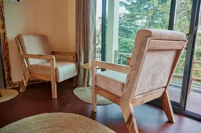 a room with two chairs and a window at Samora River Lodge in Arusha