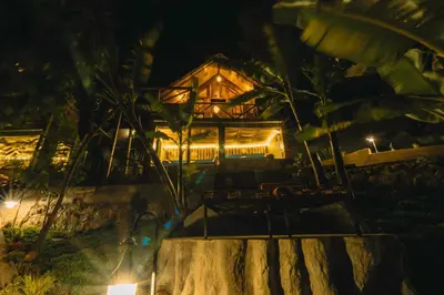 a house at night with lights in front of it at Samora River Lodge in Arusha