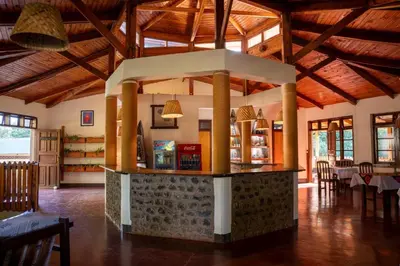 a restaurant with a counter in the middle of a room at Kilimanjaro Lodge - MCF in Moshi