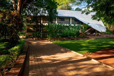 a brick walkway in front of a building at Kilimanjaro Lodge - MCF in Moshi