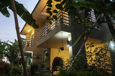 a house with a balcony with plants in front of it at Mama Ket Homes Apartment in Arusha