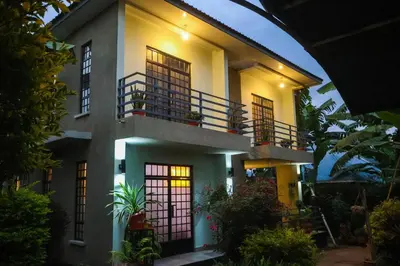 a house with a balcony in the night at Mama Ket Homes Apartment in Arusha