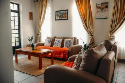 a living room with a couch and a table at Mama Ket Homes Apartment in Arusha