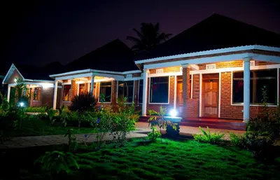 a home lit up at night with lights at Siafu Serenity Lodge in Mto wa Mbu