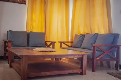 a living room with a couch and a coffee table at Makinihomestay in Arusha